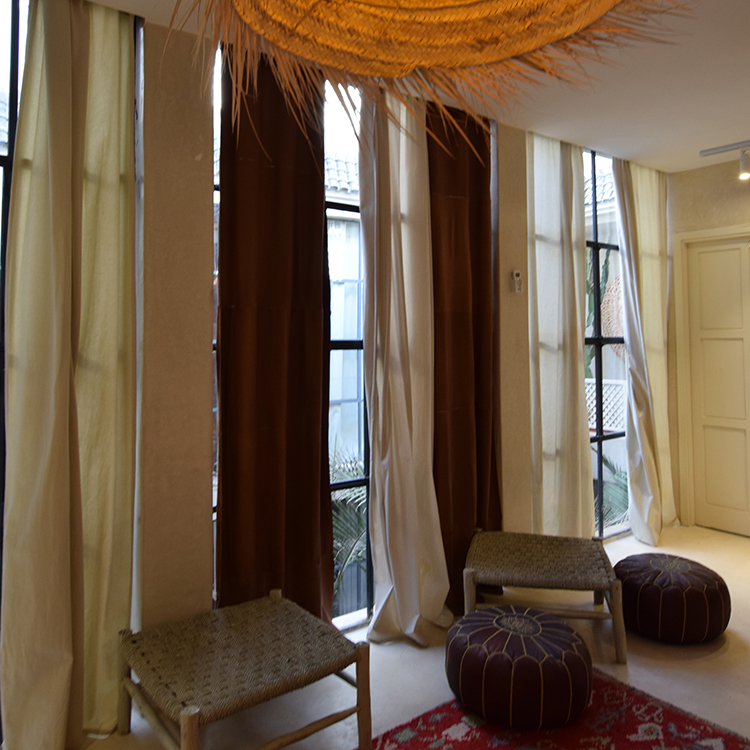 private suite room 4 Seating corner with woven stools and long curtains in the private suite room